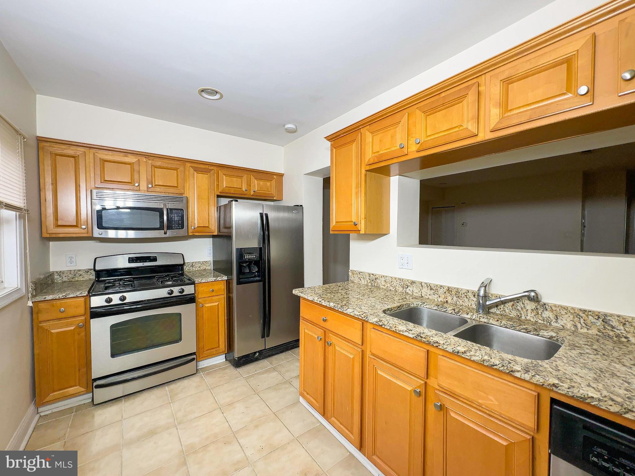1835 D Street Northeast Washington, DC 20002 - Photo 37 of 42 a kitchen with stainless steel appliances granite countertop a sink stove and refrigerator
