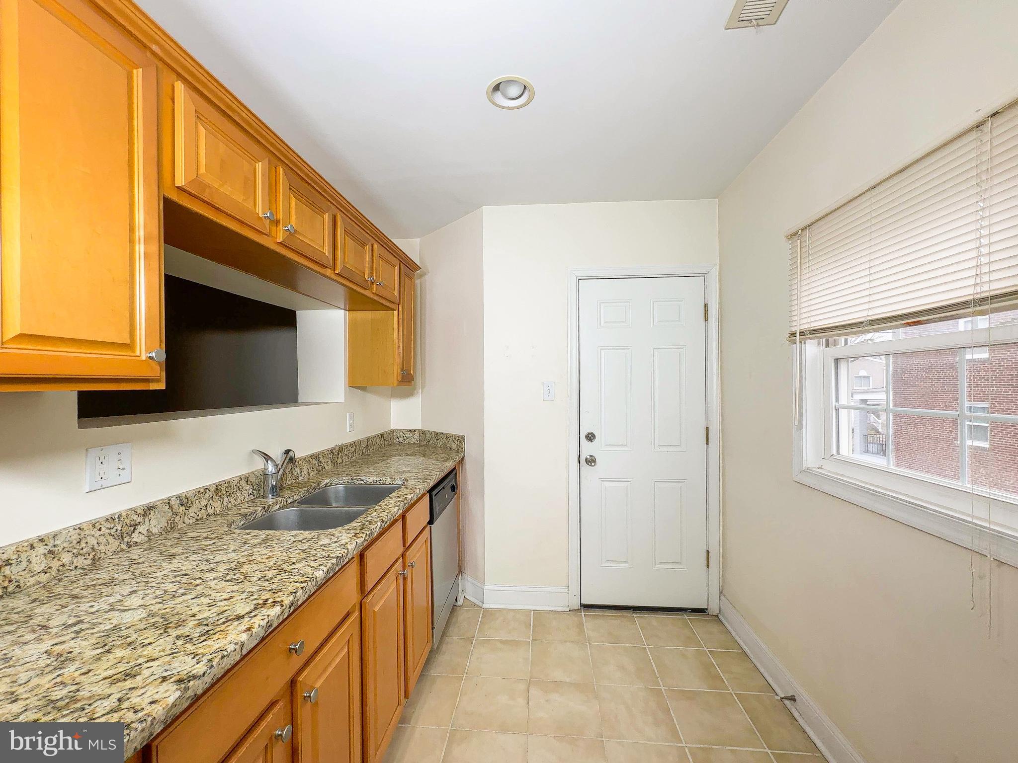 1835 D Street Northeast Washington, DC 20002 - Photo 39 of 42 a kitchen with granite countertop a sink and a stove