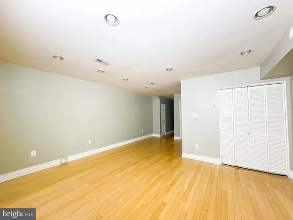 a view of a room with wooden floor