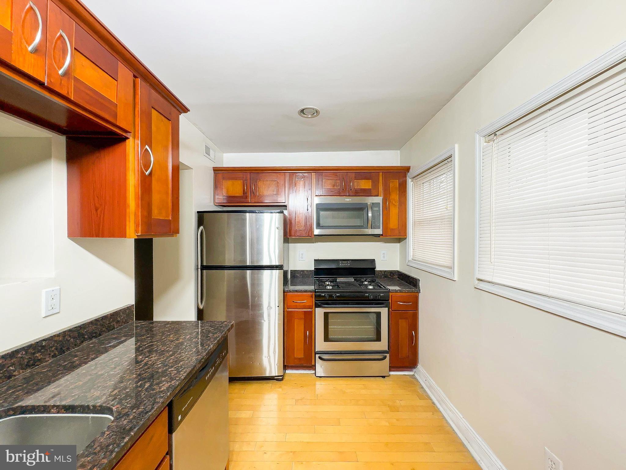 1835 D Street Northeast Washington, DC 20002 - Photo 5 of 42 a kitchen with stainless steel appliances granite countertop a refrigerator stove and oven
