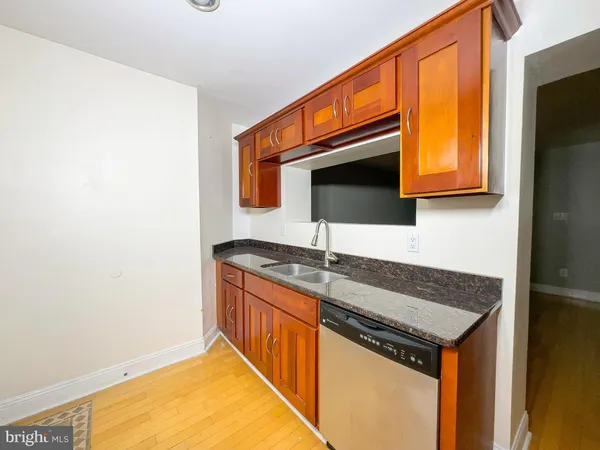 a kitchen with stainless steel appliances granite countertop a sink and a microwave