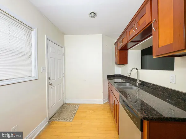 a kitchen with granite countertop a sink and a stove