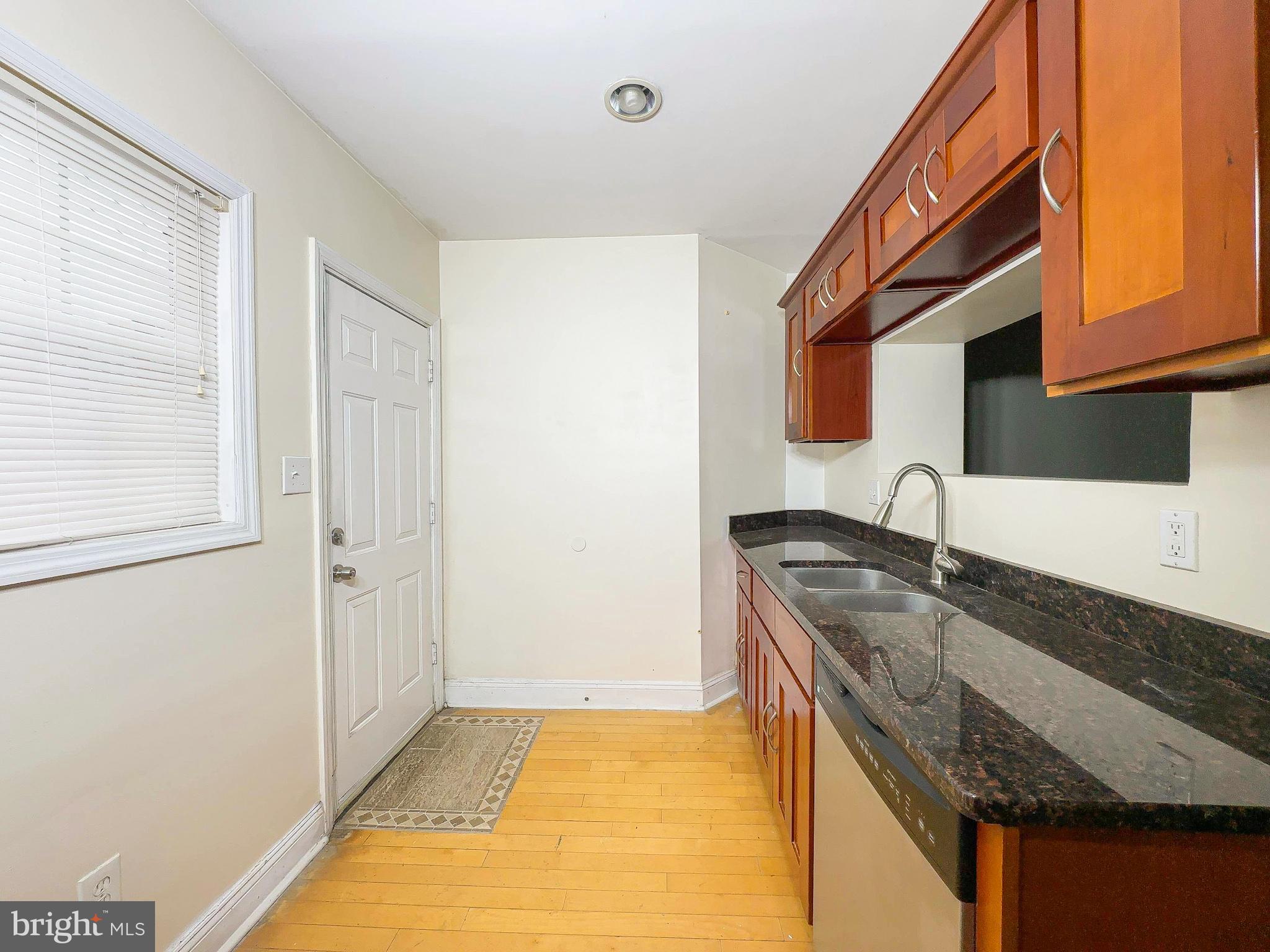 1835 D Street Northeast Washington, DC 20002 - Photo 7 of 42 a kitchen with granite countertop a sink and a stove