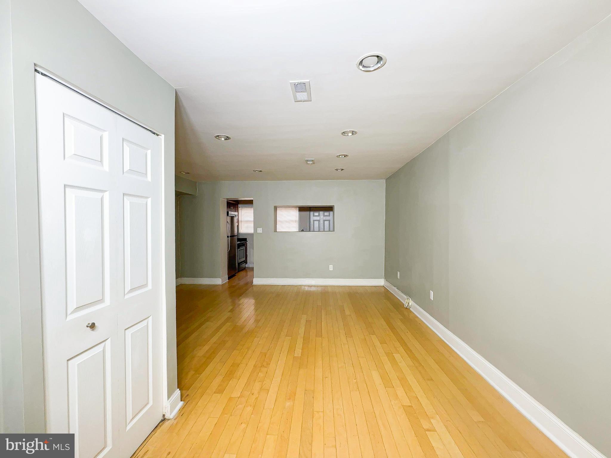 1835 D Street Northeast Washington, DC 20002 - Photo 10 of 42 a view of an empty room with wooden floor and a window