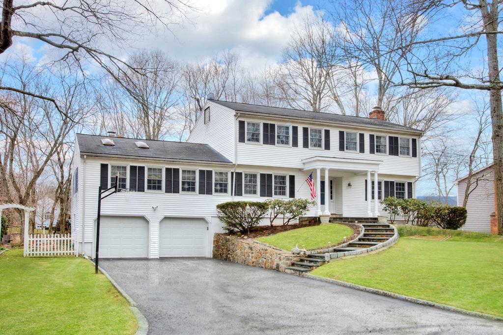 5 Country Club Road Darien, CT 06820 - Photo 1 of 20 a front view of a house with a yard table and chairs