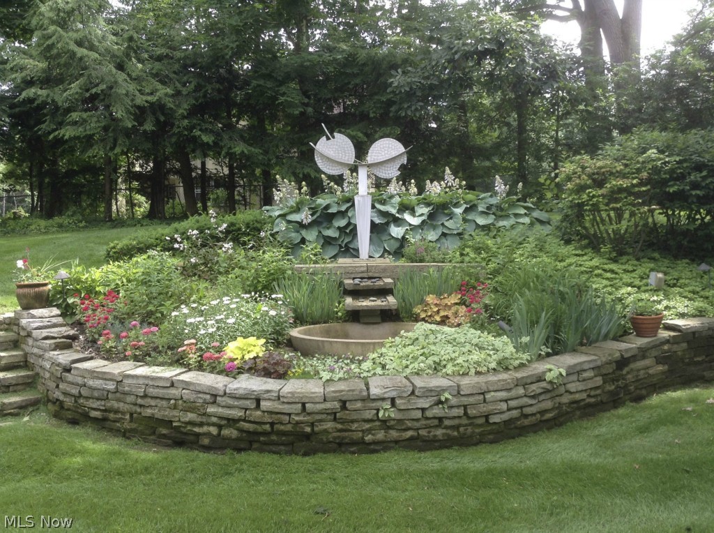 942 Genesee Road Akron, OH 44303 - Photo 22 of 23 Mature perennial beds with striking sculpture is surrounded by charming stone walls
