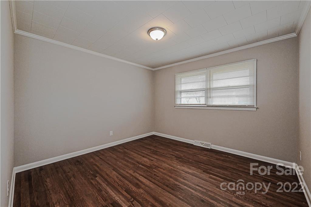 799 Sunderland Road Southwest Concord, NC 28027 - Photo 13 of 26 a view of an empty room with wooden floor and a window