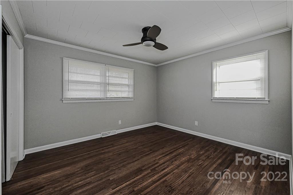 799 Sunderland Road Southwest Concord, NC 28027 - Photo 14 of 26 a view of an empty room with wooden floor and a window