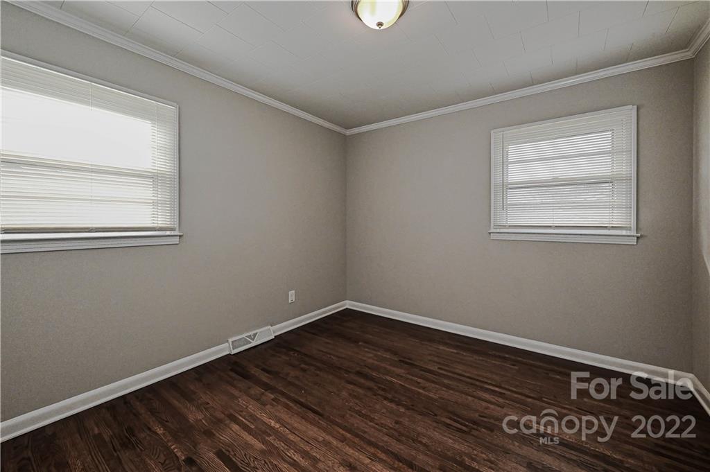 799 Sunderland Road Southwest Concord, NC 28027 - Photo 17 of 26 an empty room with wooden floor and windows