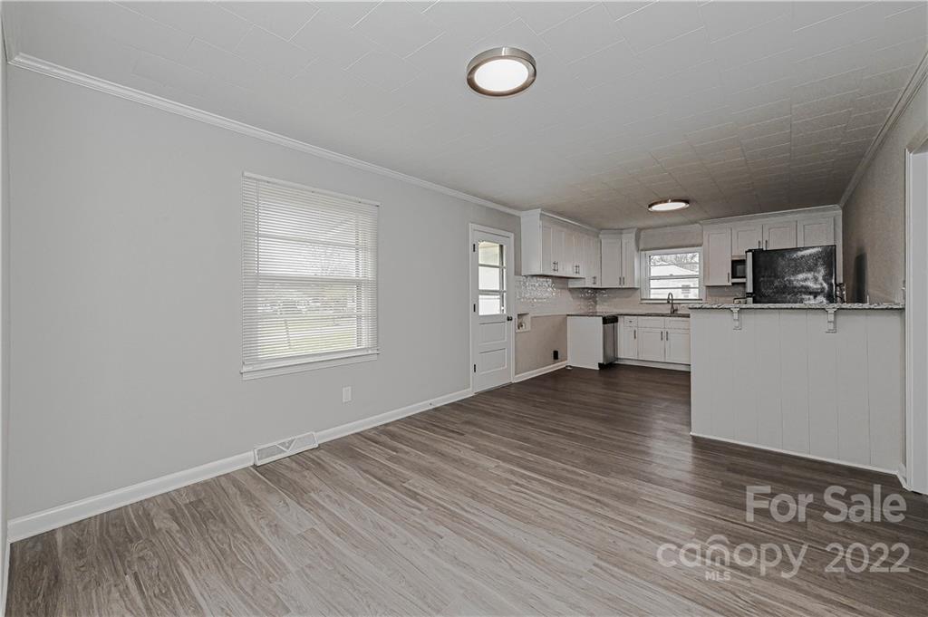 799 Sunderland Road Southwest Concord, NC 28027 - Photo 6 of 26 a view of kitchen with wooden floor and window