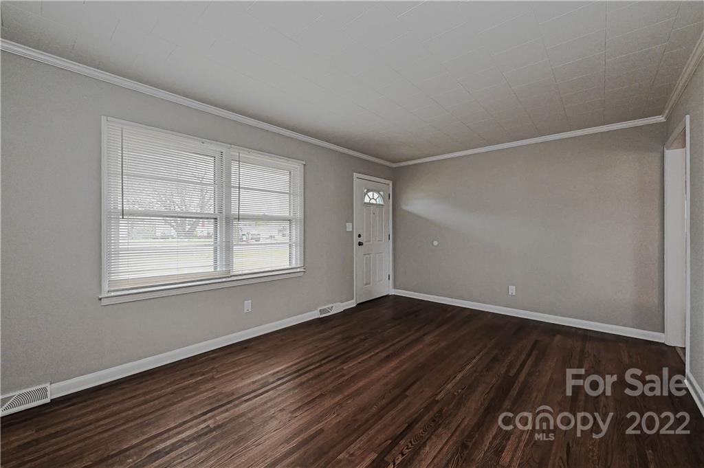 799 Sunderland Road Southwest Concord, NC 28027 - Photo 9 of 26 a view of an empty room with wooden floor and a window