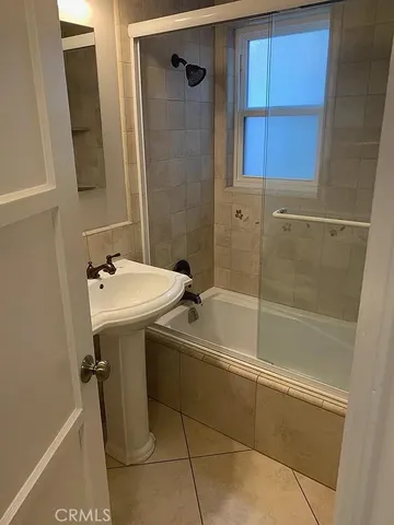 a bathroom with a glass shower door