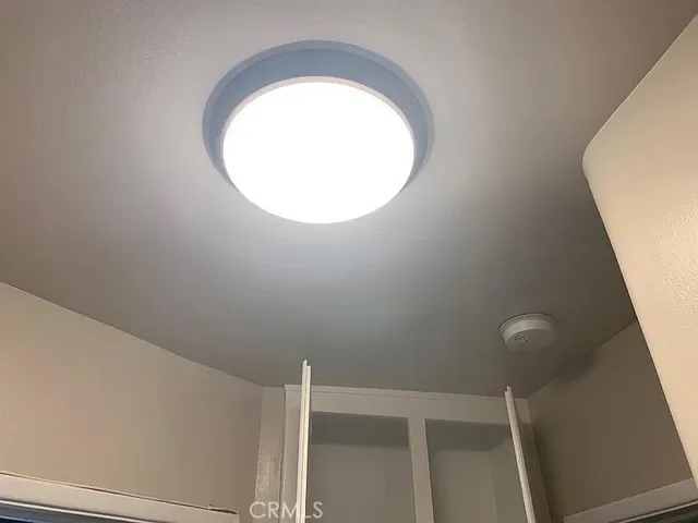 a kitchen with sink a stove and wooden floor