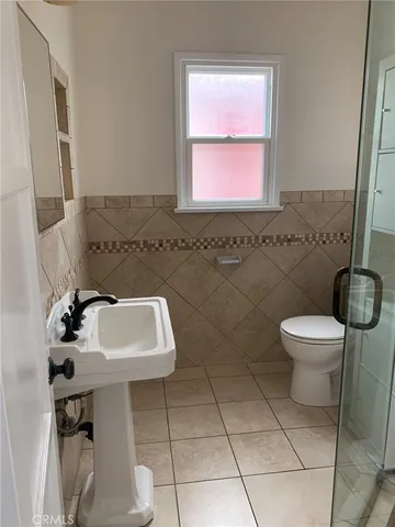 a bathroom with a glass shower door
