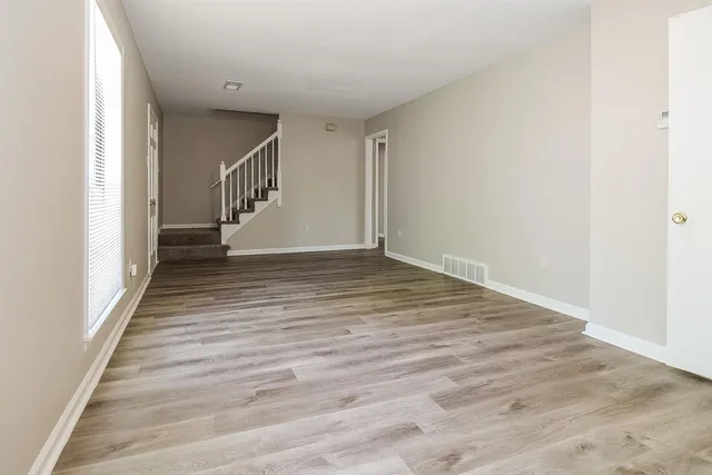 a view of a hallway with wooden floor