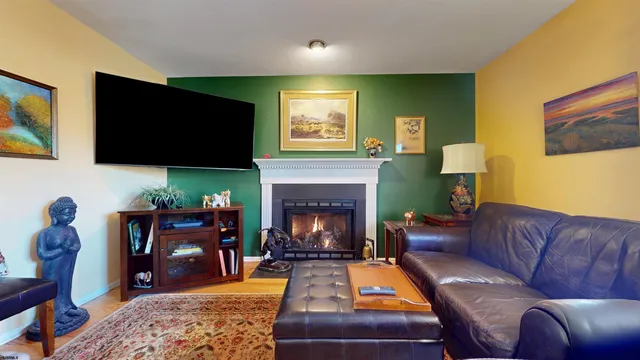 a living room with furniture fireplace and a window