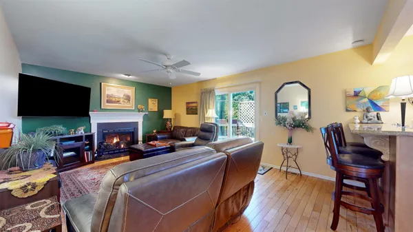 a living room with fireplace furniture and a flat screen tv