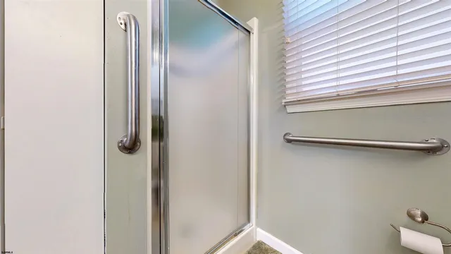 a bedroom with a bed furniture and a large window