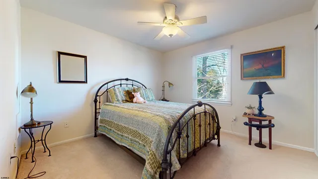 a bedroom with a bed and a mirror on dresser