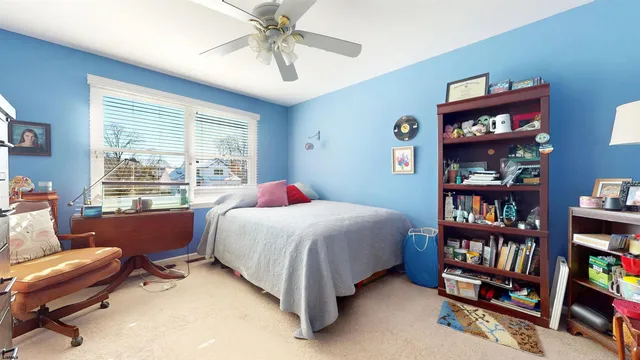 a bedroom with a bed chair and a window