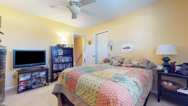 a spacious bedroom with a bed and furniture