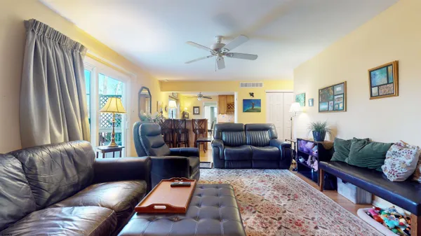 a living room with furniture fireplace and a window