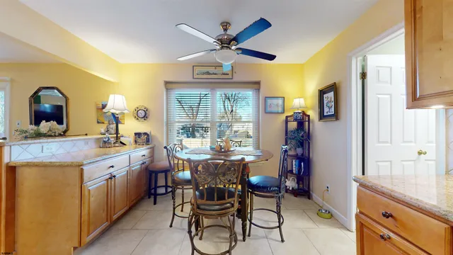 a dining room with furniture a chandelier and wooden floor