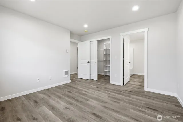 a view of empty room with wooden floor