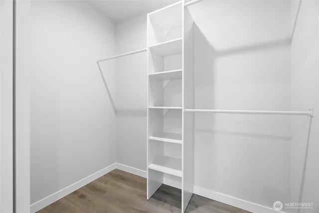 a view of walk in closet with empty racks