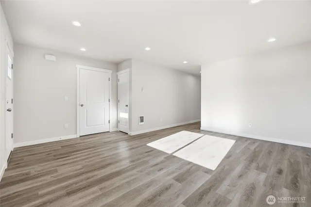 an empty room with wooden floor