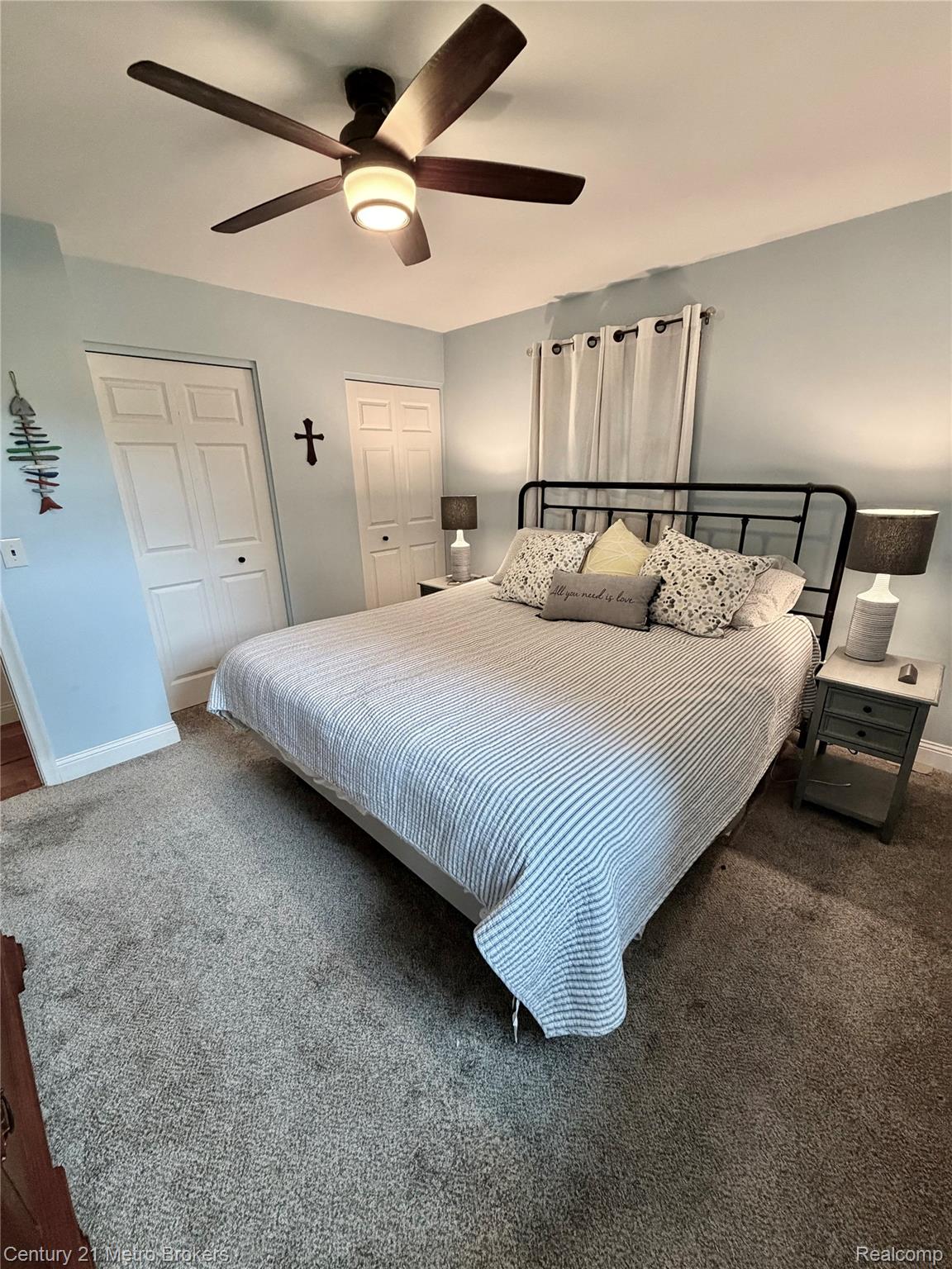 3259 North Seymour Road Flushing, MI 48433 - Photo 37 of 49 Carpeted room featuring a ceiling fan with integrated lighting, two bi-fold closet doors, and light blue wall paint
