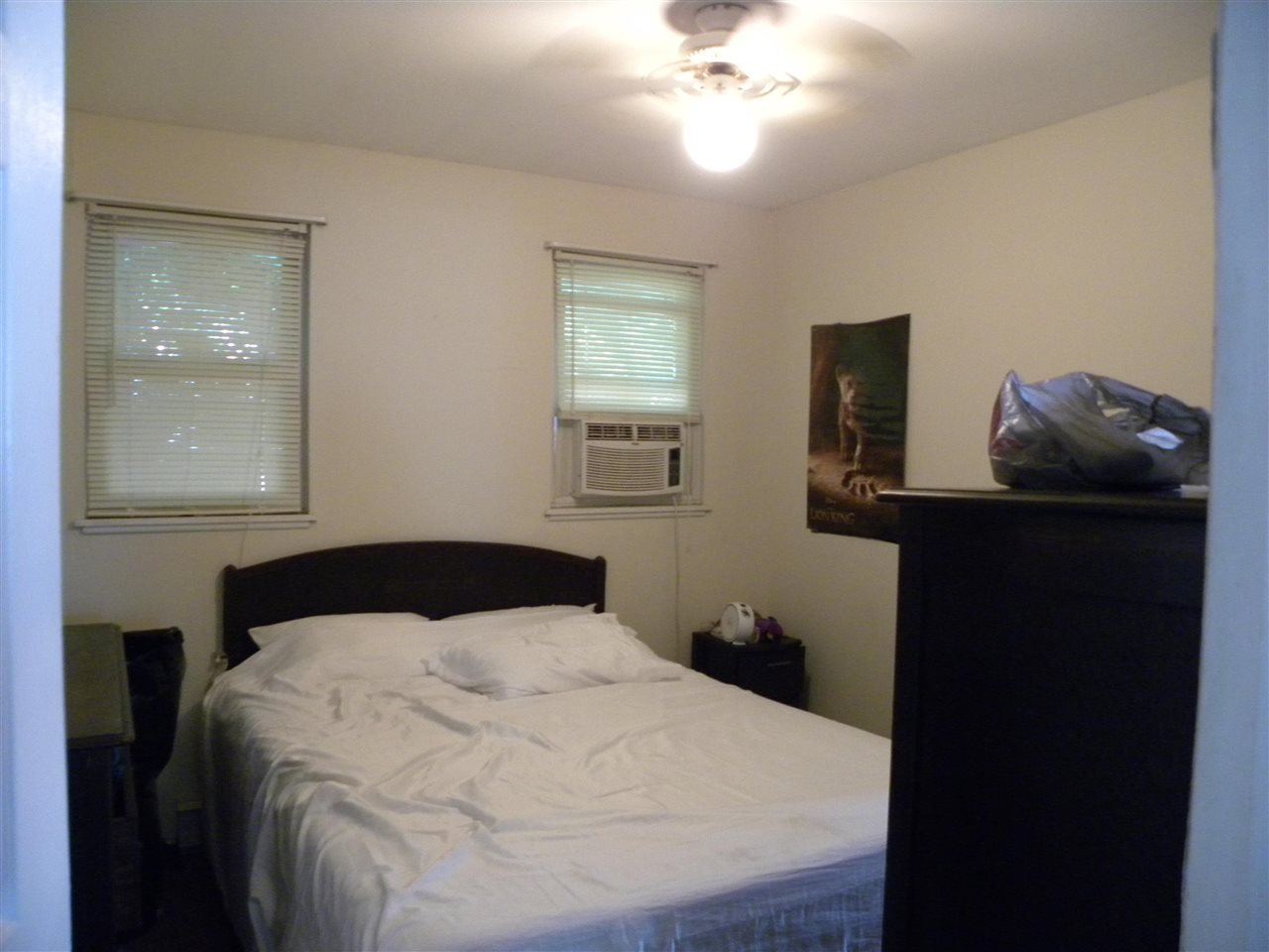 52 Warwick Road Villas, NJ 08251 - Photo 13 of 20 a bedroom with a bed and a chandelier