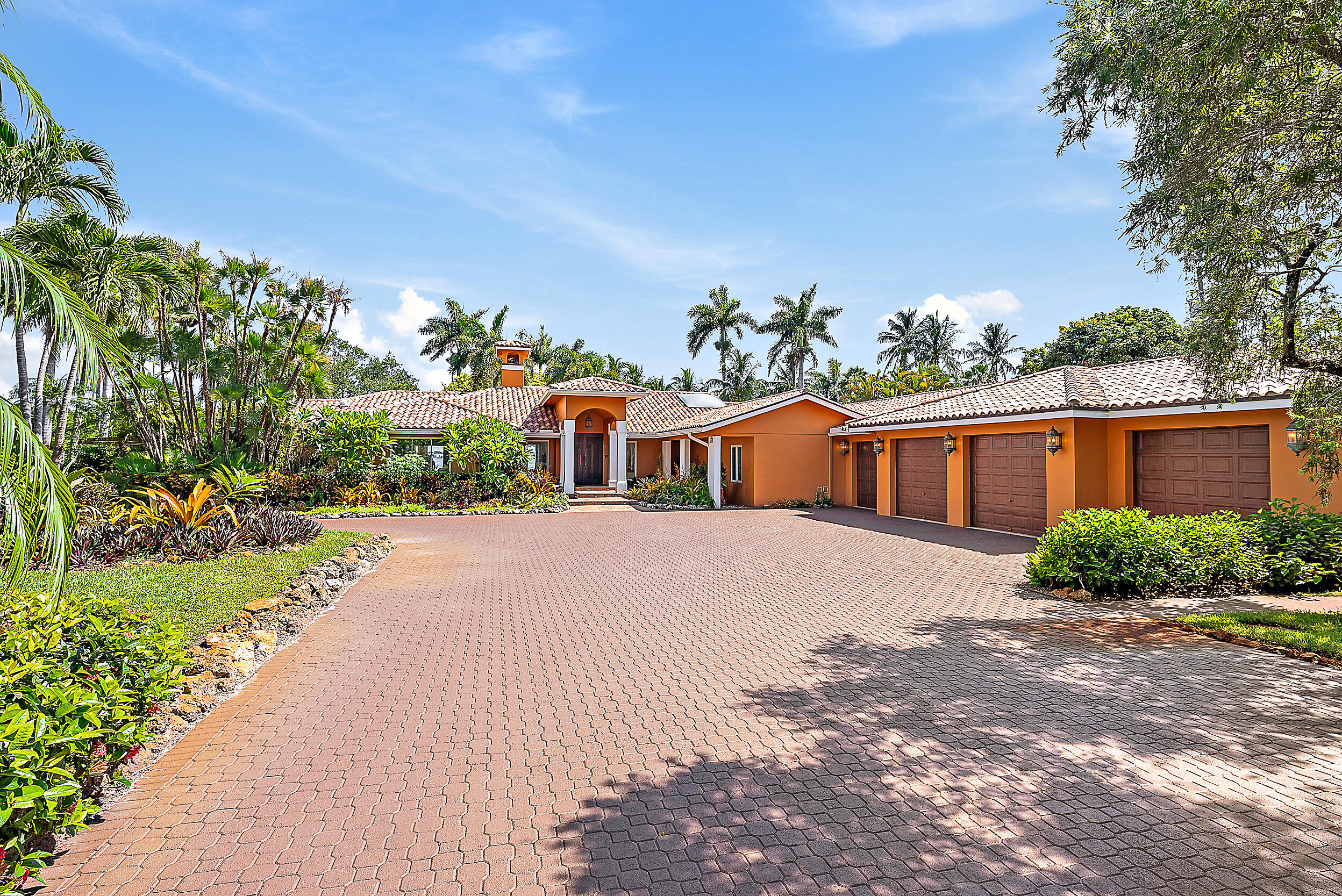 5900 Pennock Point Road Jupiter, FL 33458 - Photo 11 of 21 a front view of a house with a yard and a garage