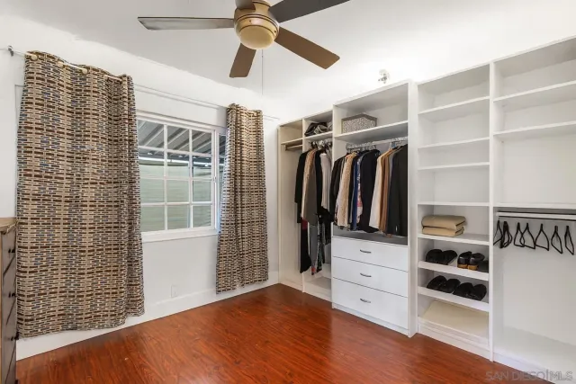 a view of walk in closet with empty racks