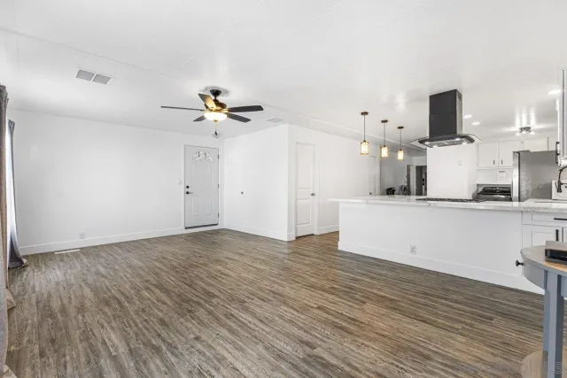 a view of a kitchen with wooden floor and a sink