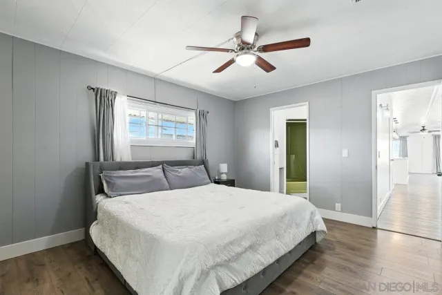 a bedroom with a large bed and a window