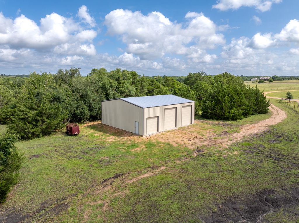 7650 Rolling Creek Road Burton, TX 77835 - Photo 22 of 22 a backyard of a house with lots of green space