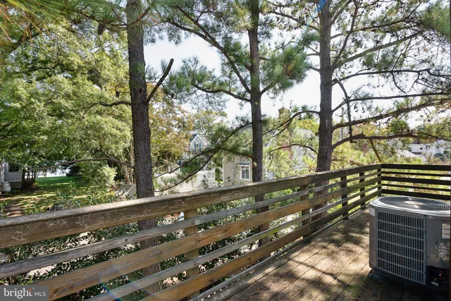 a view of a yard with wooden fence