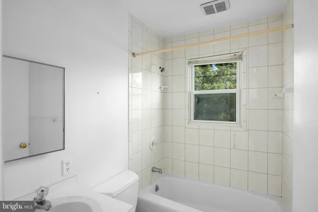 a bathroom with a bathtub and shower