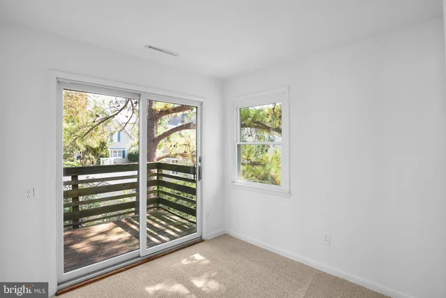an empty room with large windows