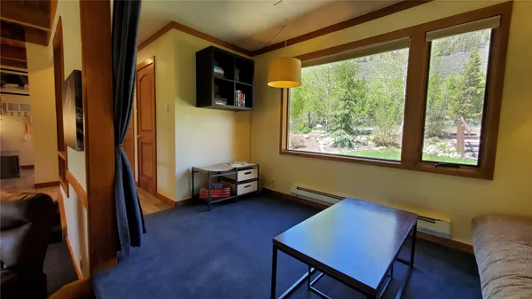 a view of a livingroom with furniture and a window