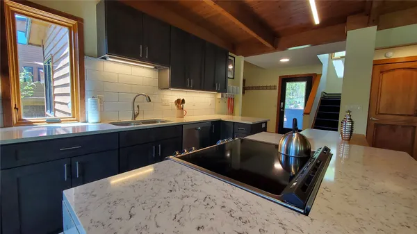 a kitchen with a sink and wooden cabinets