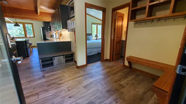a view of a livingroom with wooden floor and furniture