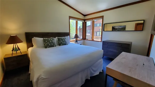 a bedroom with a bed and a night stand