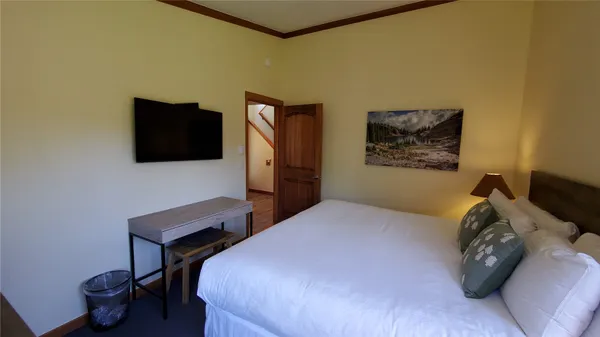 a bedroom with a bed and a flat screen tv