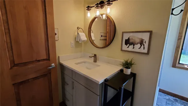 a bathroom with a sink and a mirror