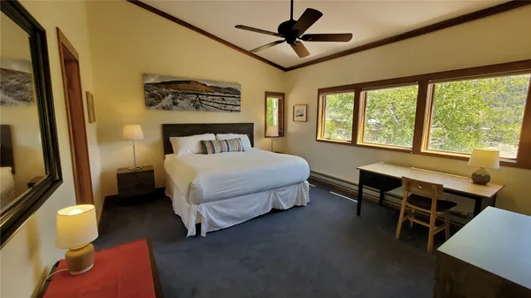 a bedroom with a bed and a table in it