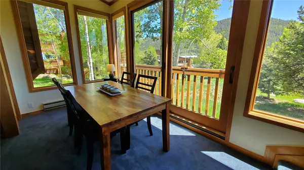 a view of a room with a table and chairs