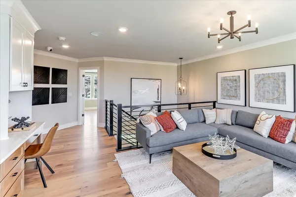 a living room with furniture and a view of kitchen