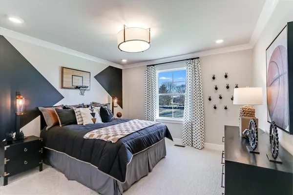 a bedroom with a large bed and a flat tv screen on dresser